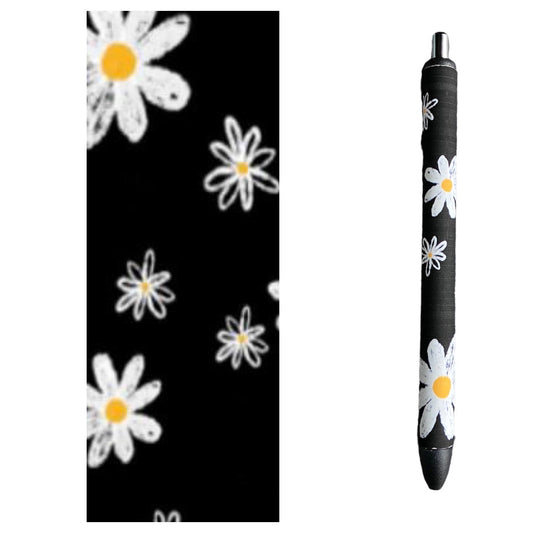 Photo of pen and vinyl design with black background and white flowers. 