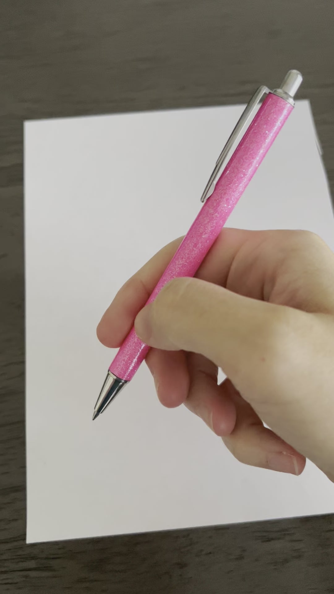 Video of the pink metal glitter body pen being shown writing. 